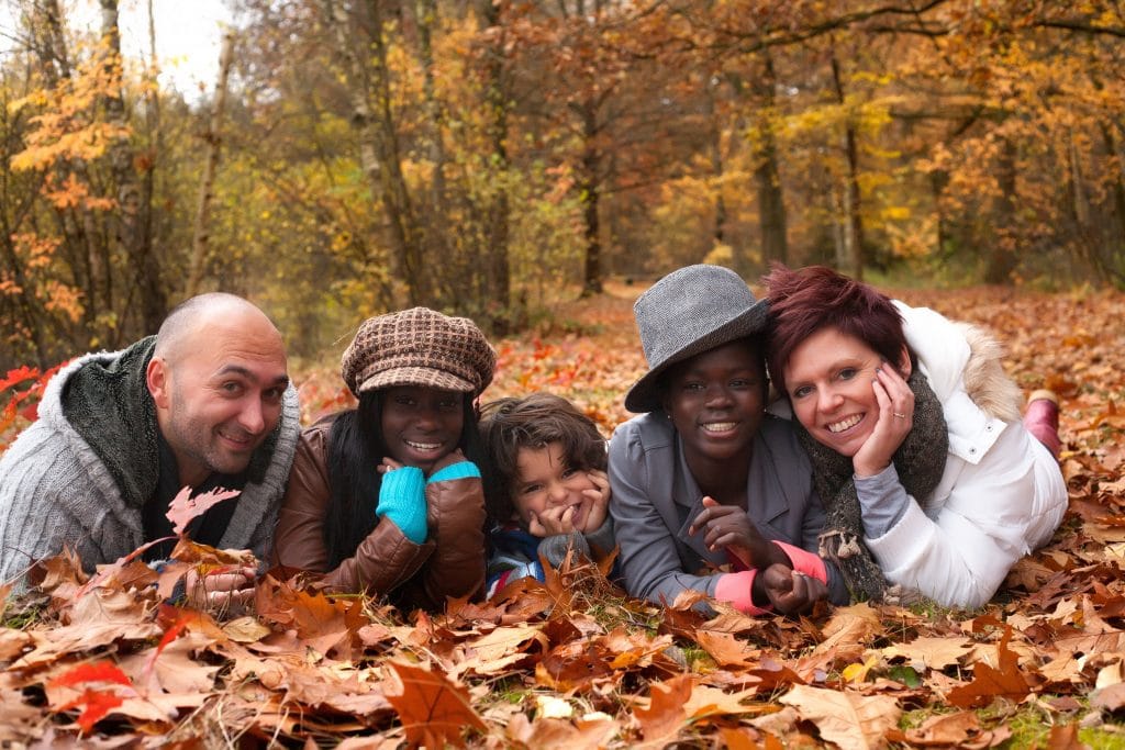 group smiling in leaves