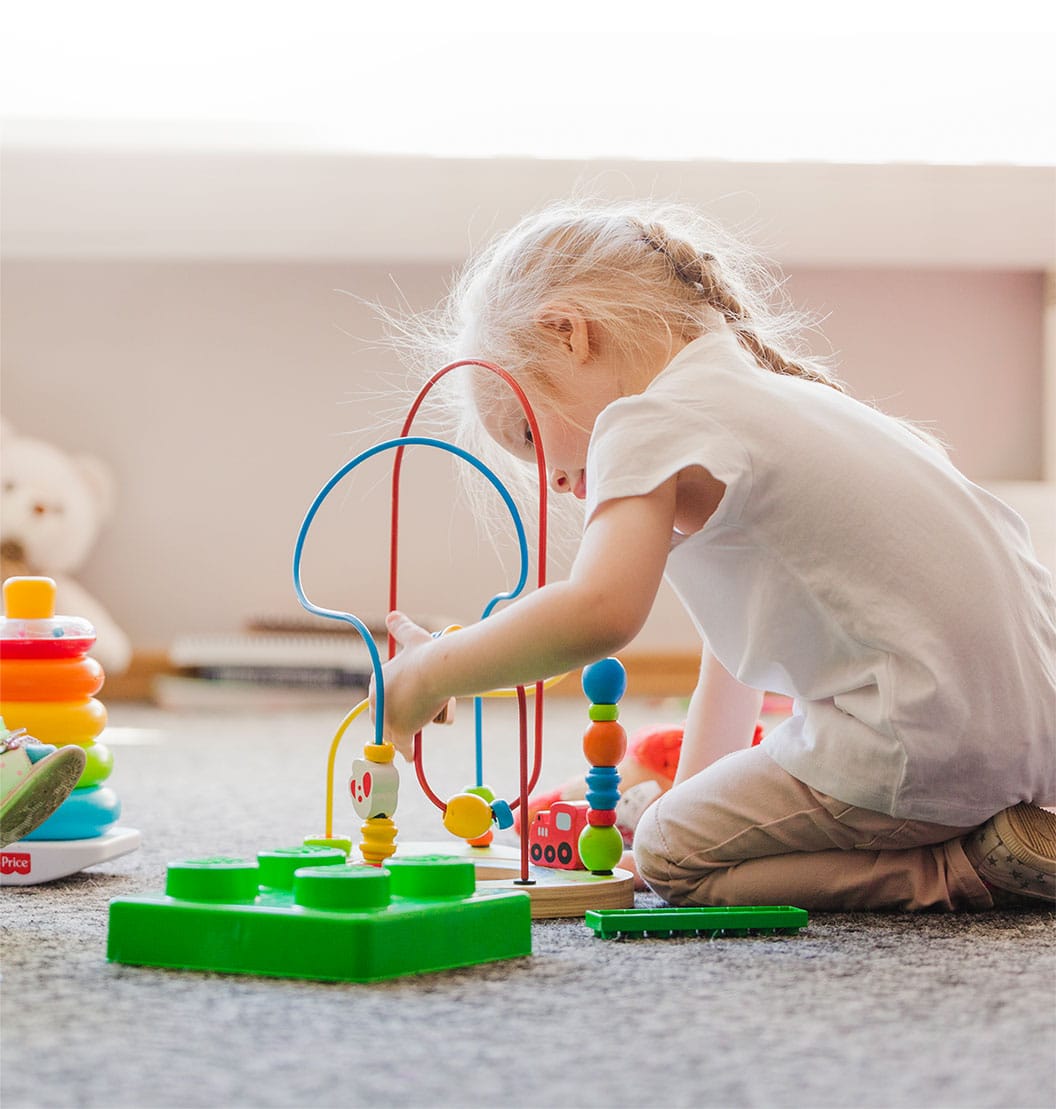 young child playing with toy