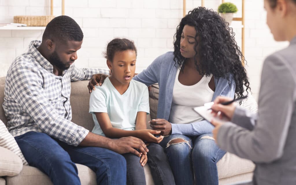 girl and her parents at psychologist consultation