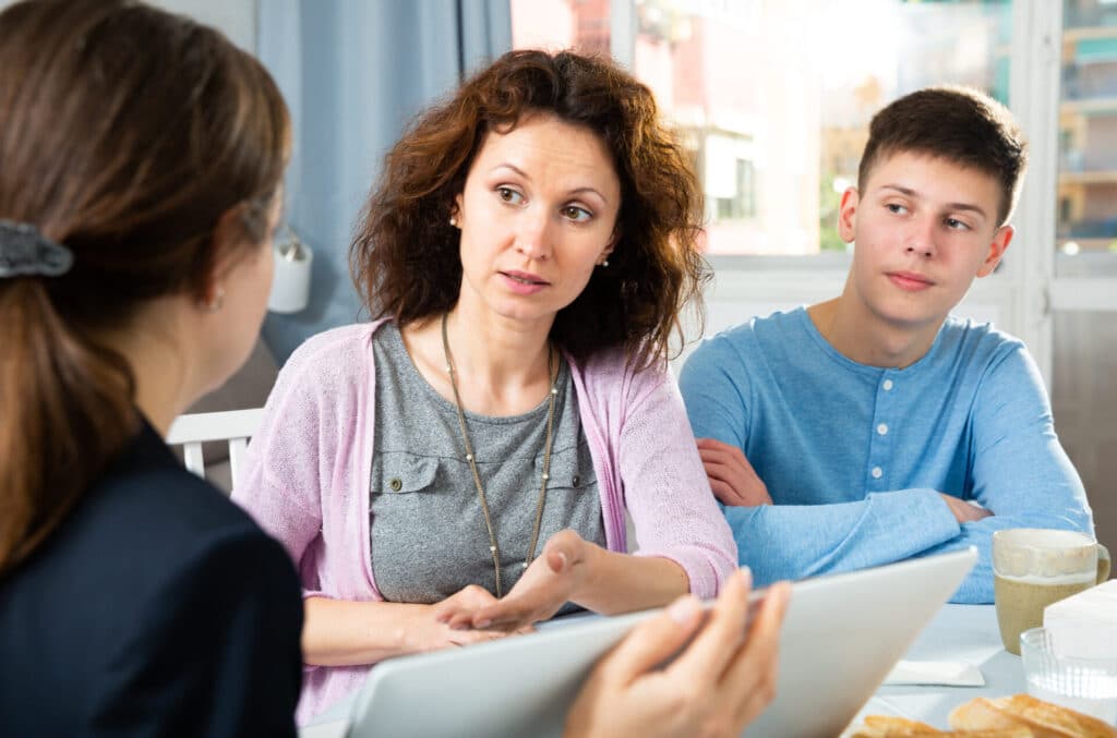 mom and son meeting with social services